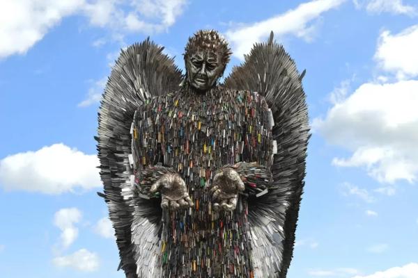 A photo of the Knife Angel, a 27-feet-tall statue created from over 100,000 knives and blades confiscated by the UK’s 43 police forces.